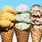 Five ice cream cones with different flavors and toppings are lined up against a blue background.